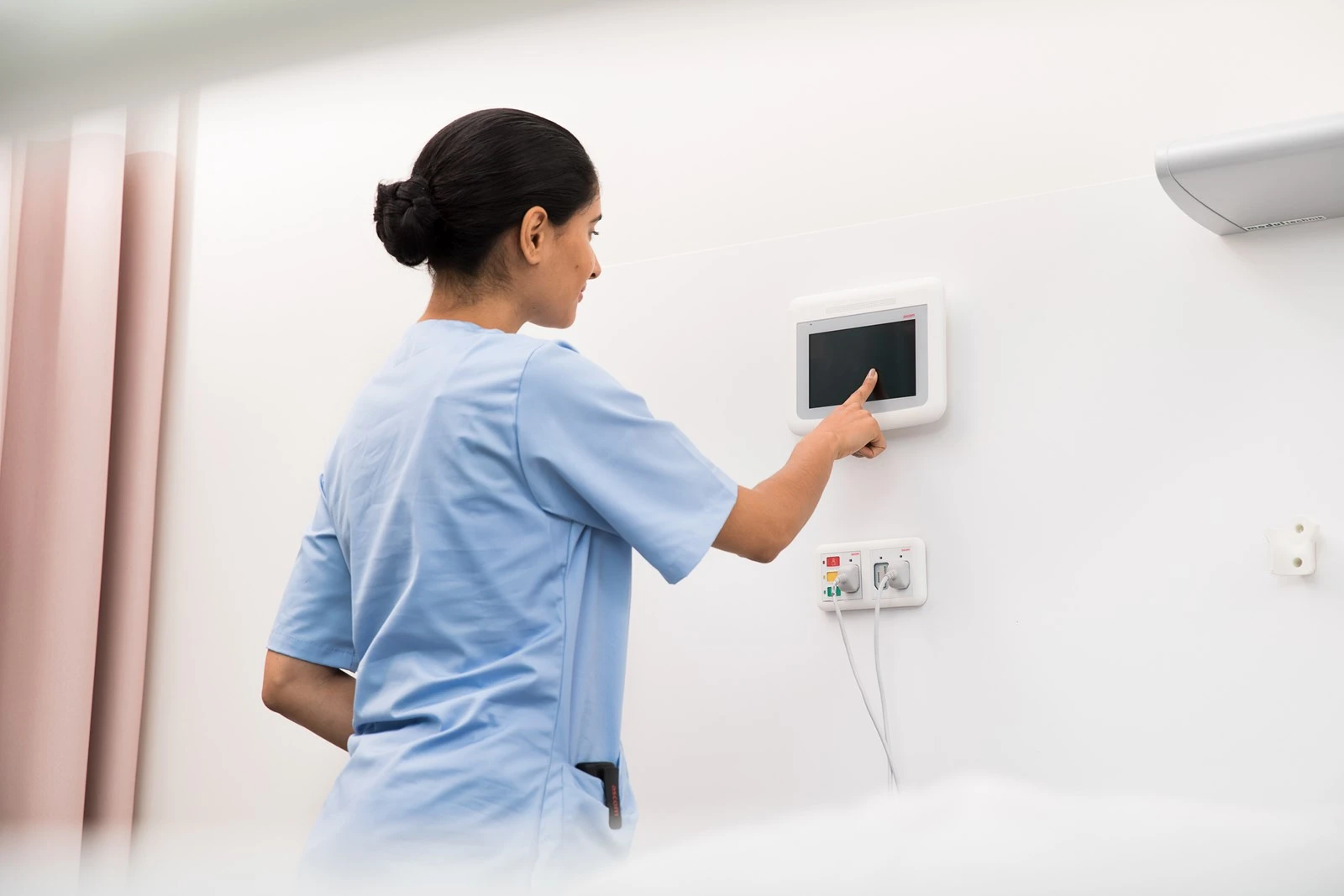 Ascom Telligence nurse call system components — dome lights, nurse station display, and wall modules